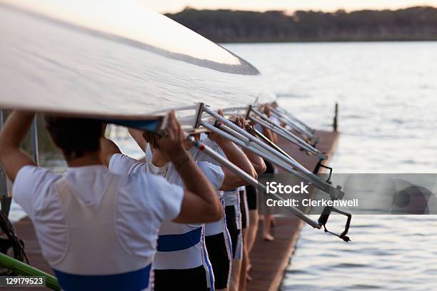 Men Carrying Long Canoe Over Hear Stock Photo - Download Image Now - Sports Team, Teamwork, Togetherness