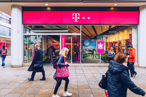 Stuttgart, Germany - October 19, 2019: T-Mobile store with people. T-Mobile is the brand name used by the mobile communications subsidiaries of the German telecommunications company Deutsche Telekom