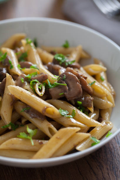 istock Penne pasta with mushrooms on a plate. 1291796957