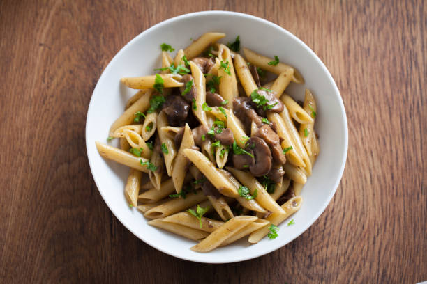 istock Penne pasta with mushrooms on a plate. 1291797256