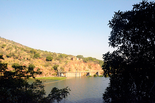 A beautiful lake with hills and village in the background in Johannesburg, South Africa
