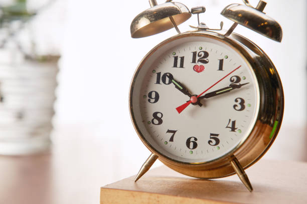 istock vintage alarm clock on top of  book 1291797730