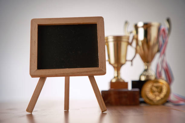 istock trophy and medal information blackboard on wooden table 1291798471
