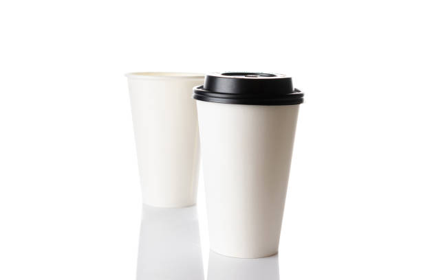 istock White paper cup for hot coffee with black lid isolated on white background. Takeaway blank small tea cup for your design text or banner of brand. 1291798558