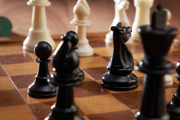 istock White and black pieces on chess board 1291798871