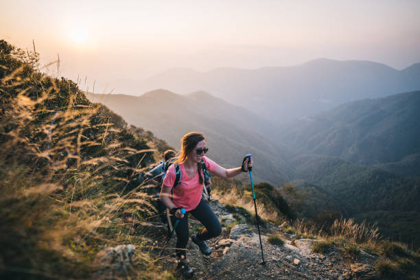 istock Friends hike along sunny mountain ridge at sunrise 1291800682