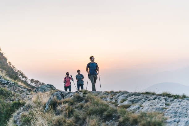 istock Friends hike along sunny mountain ridge at sunrise 1291800837