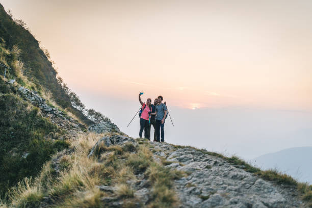 istock Friends hike along sunny mountain ridge at sunrise 1291800879