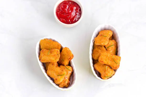Chicken Nuggets with Ketchup Directly Above ob White Background