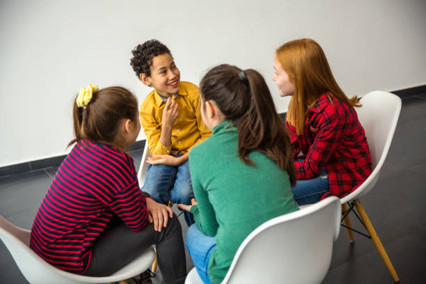istock Group of children smiling and talking 1291801707
