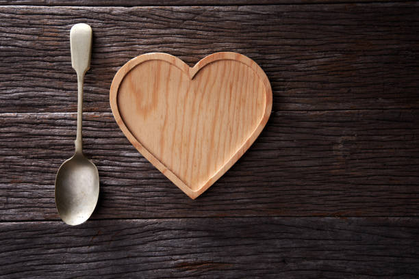 istock antique spoon and heart shape container on wooden background 1291802425