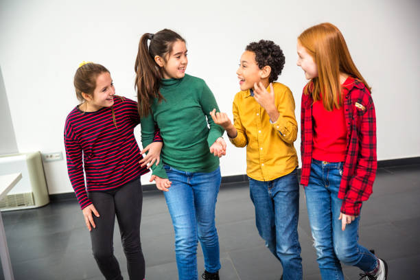 istock Group of children smiling, talking and walking 1291803109
