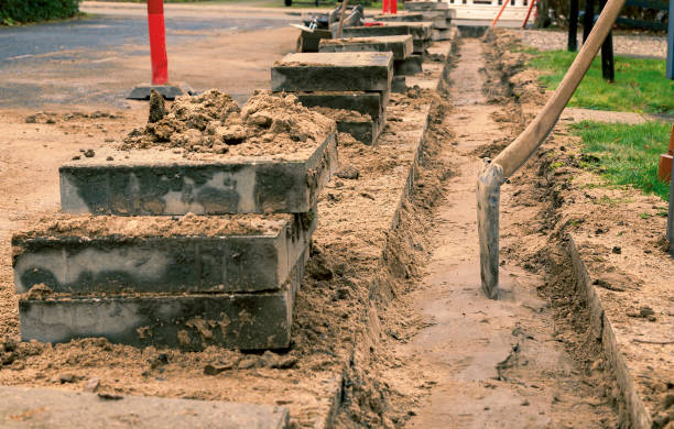 istock Digging the sidewalk for fibrenet installation 1291805249
