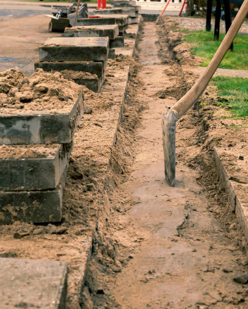istock Digging the sidewalk for fibrenet installation 1291805269