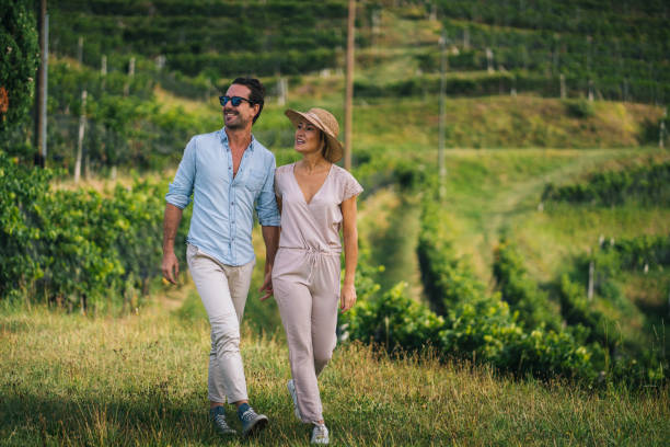 istock Couple walk through vineyard in the morning 1291805910