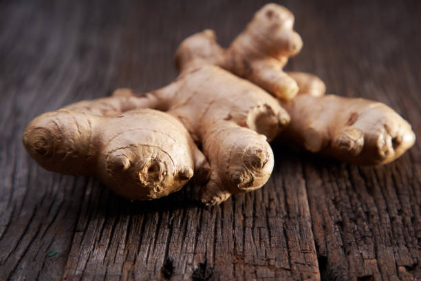 istock close up of ginger root on wood background 1291806315