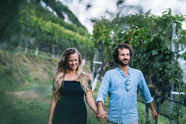 istock Couple walk through vineyard in the morning 1291806527