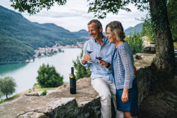 mature couple enjoy some red wine in italian vineyard - senior adult cheerful adventure discovery imagens e fotografias de stock