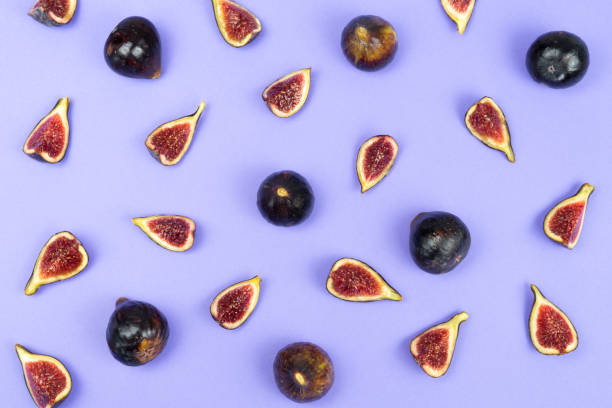 istock Cut and whole figs on a blue background. Copy space. 1291809887