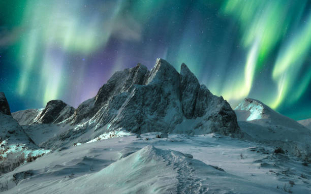 Aurora borealis over majestic mountain in snowy on Segla Island Aurora borealis over majestic mountain in snowy on Segla Island, Norway senja island photos stock pictures, royalty-free photos & images