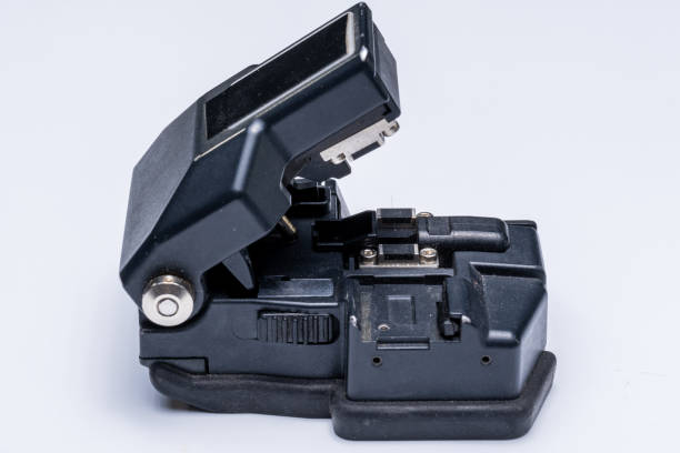 istock Optical fiber cutter for subsequent splice, close-up on white 1291814212