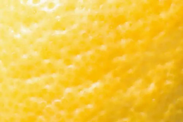 Photo of Lemon close up - illuminating yellow color. Optimistic hue of yellow is color of the year 2021