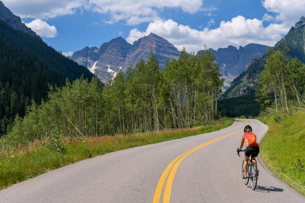Biking to Maroon Bells - Bike riding on Marron Creek Road, from Highlands to Marron Lake, is the best way to enjoy this one of Colorado's most scenic areas. Aspen, Colorado, USA. stock photo
