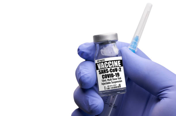 istock Hand holding covid-19 vaccine and syringe on white background 1291816930
