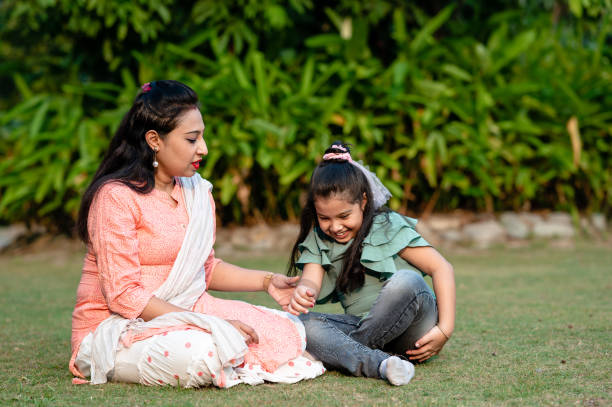 istock Loving mother and daughter playing with each other at park 1291817056