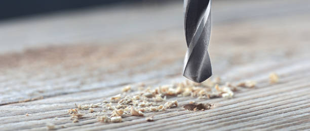 istock metal drill bit make holes in old wooden plank 1291818987