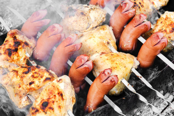 Sausages are fried on the grill. Grilled meat. Chicken wings. Smoke