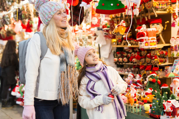 istock Smiling woman with tweenage daughter pointing to something while choosing decorations on traditional market 1291819439