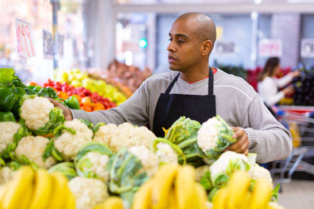 istock Man working  in  supermarket near  vegetable  section 1291820459
