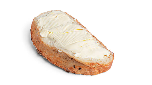 istock A piece of bread with butter isolated on white background 1291821718