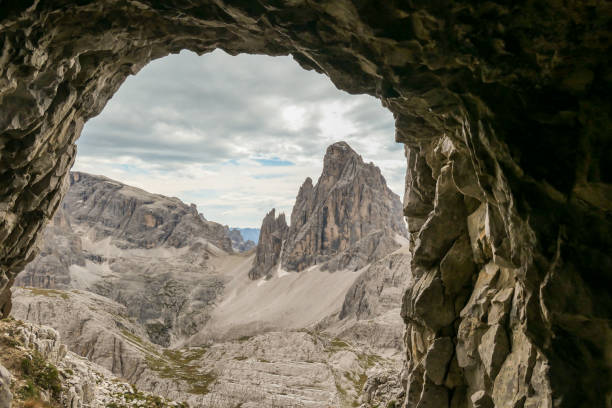 istock Oberbachernspitze - A view from a cave on distant and high mountain chain in Italian Dolomites. 1291823018