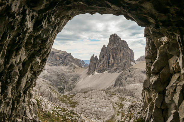 istock Oberbachernspitze - A view from a cave on distant and high mountain chain in Italian Dolomites. 1291823122