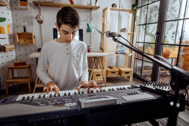 istock Teenager boy playing synthesizer 1291824154