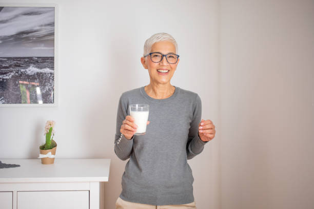 istock Senior woman drinking milk at home. 1291825325