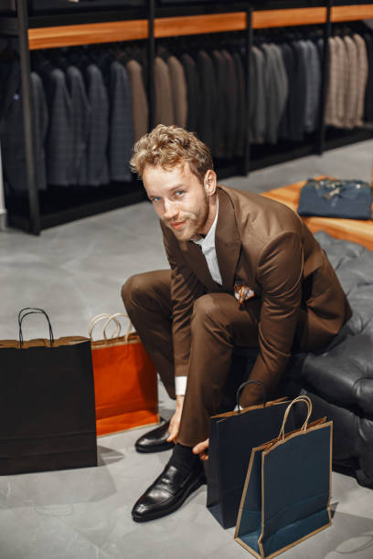 istock Handsome man with beard choosing shoes in a shop 1291826650