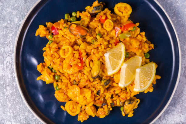 istock Freshly cooked seafood paella on a blue plate 1291827471