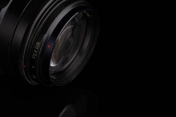 istock old manual lens with reflection isolated on black 1291829780
