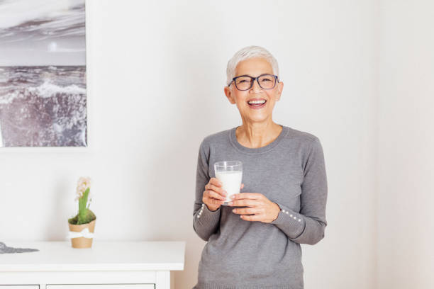 istock Senior woman drinking milk at home. 1291830770