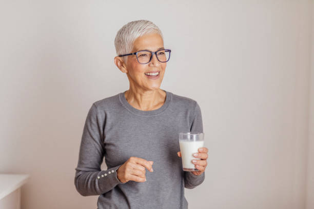 istock Senior woman drinking milk at home. 1291830779