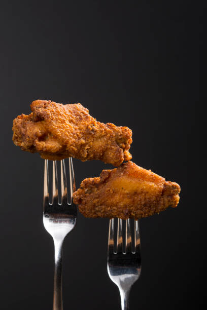 istock Breaded Fried chicken wings drum and flat on a fork with copy area 1291832862