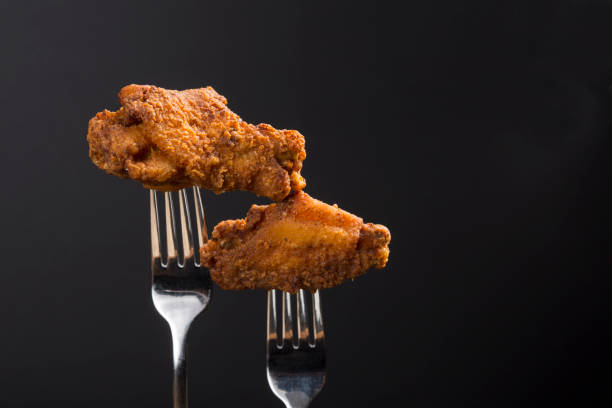 istock Breaded Fried chicken wings drum and flat on a fork with copy area 1291832907