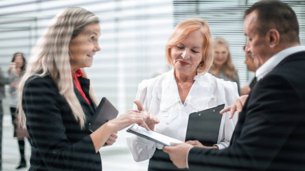 istock close up. smiling business partners discussing business documents 1291834023