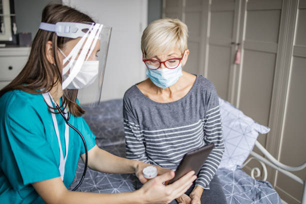 istock Female doctor and home care 1291834227
