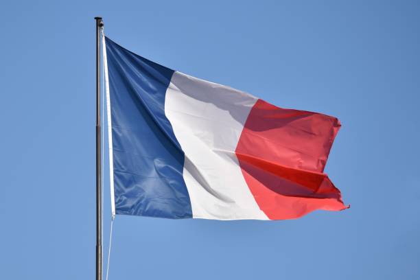 istock French flag fluttering in a clean blue sky 1291835052