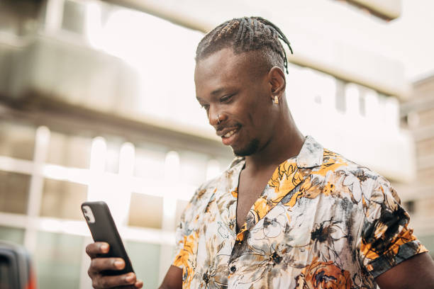 istock Young man walking in the city and using smart phone 1291835388