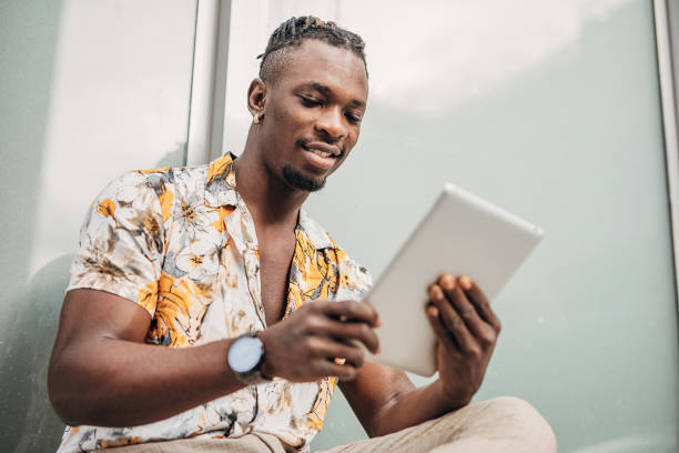 istock One young handsome man using digital tablet outdoors in the city 1291835506